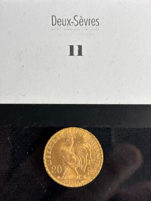 a close up of a gold coin in a box on a table