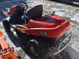 a small red motorcycle parked next to a small red car