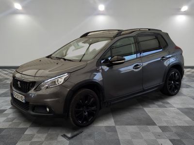 a grey car parked on a checkered floor in a garage