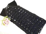 a black bag with a flower on it sitting on a table