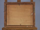 an old wooden easel with a piece of wood on top of it