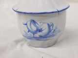a small blue and white bowl with a lid on a table