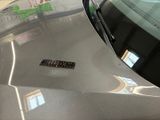 a close up of a car ' s hood with a sticker on it