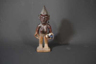 wooden statue of a man with a hat and a bird on his shoulder