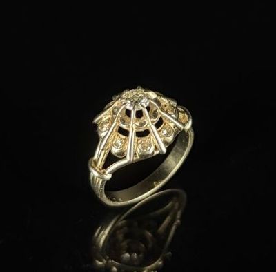 a close up of a gold ring on a black surface