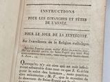 an old book that is open on a table