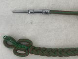 a close up of a green rope with a metal handle