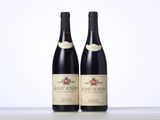 two bottles of wine sitting on top of a table next to each other