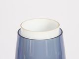 a blue vase with a white top on a table