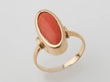 a gold ring with an oval coral stone in the center