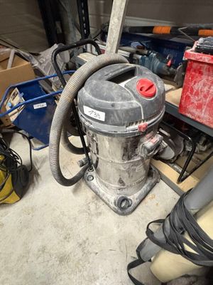 un aspirateur posé par terre dans un garage
