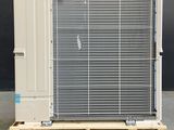 a air conditioner sitting on a pallet in front of a black wall
