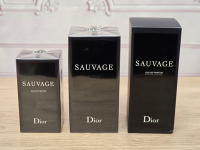 three bottles of perfume sitting on top of a table next to each other