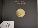 the gold coin is in a black box with a tag on it