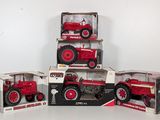 several red toy tractors are stacked on top of each other