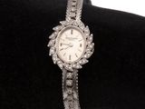 une photo d'une montre-bracelet pour femme posée sur un coussin en velours noir