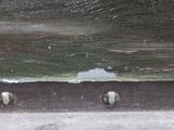 a close up of a piece of wood with nails on it
