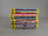 many books stacked on top of each other on a table