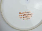 a white plate with orange writing on it on a table