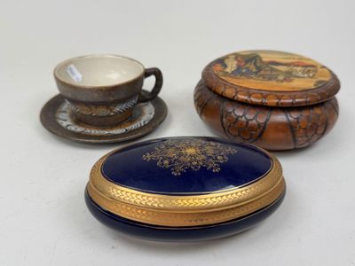 three small boxes and a cup sitting on a table