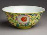 yellow and pink bowl with flowers and vines on a grey background