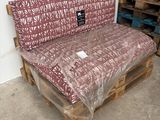 a couch made out of pallets in a warehouse