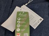 a close up of a blue shirt with a tag on it