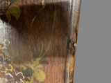 a close up of a wooden cabinet with flowers painted on it