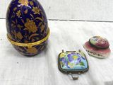 a blue egg sitting on a table next to other items