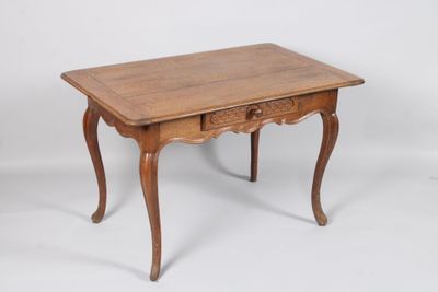 an old wooden table with a drawer on top of it