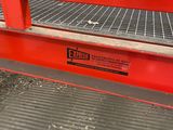 an image of a red metal work bench in a factory