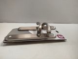 a pair of metal hooks that are on a white table
