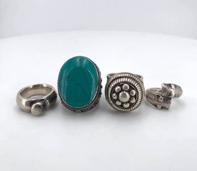 three rings and a ring with a turquoise stone on it