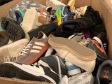 many pairs of shoes in a box on the floor