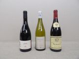 three bottles of wine sitting on a table next to each other
