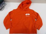 a close up of a child ' s orange hoodie on a table