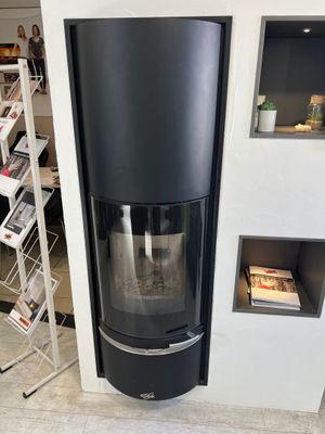 a black stove in the corner of a room