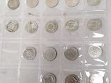 a lot of coins that are in a plastic box