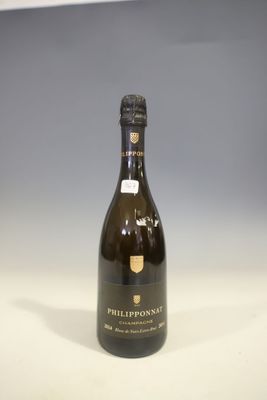 the bottle of champagne is sitting on the table