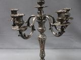 a silver candelab with five candles on it