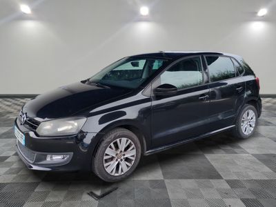 the black volkswagen polo estate is parked in the garage