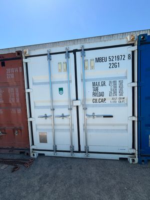 two shipping containers sitting next to each other on the ground