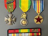 four medals and a ribbon on a table