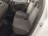 the back seats of a white car with a black seat belt