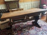 a large wooden table in the middle of a living room