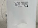a close up of a water heater sitting on top of a cement floor