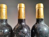 three bottles of wine that are sitting on a table
