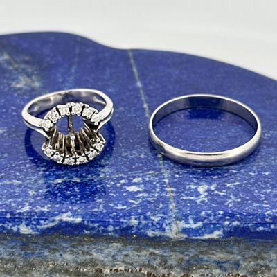 two rings sitting on top of a blue stone