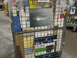 a metal cart with many boxes on it in a warehouse
