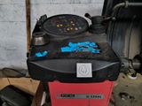 a red and black machine that is sitting in a garage